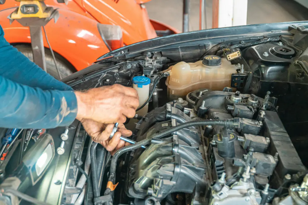 A Person Repairing Car Engine