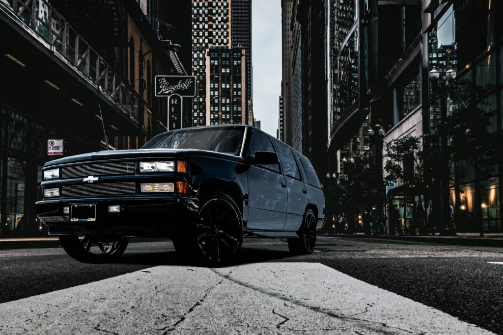 a black truck parked on the side of the road