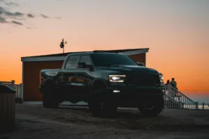a black truck parked on a beach