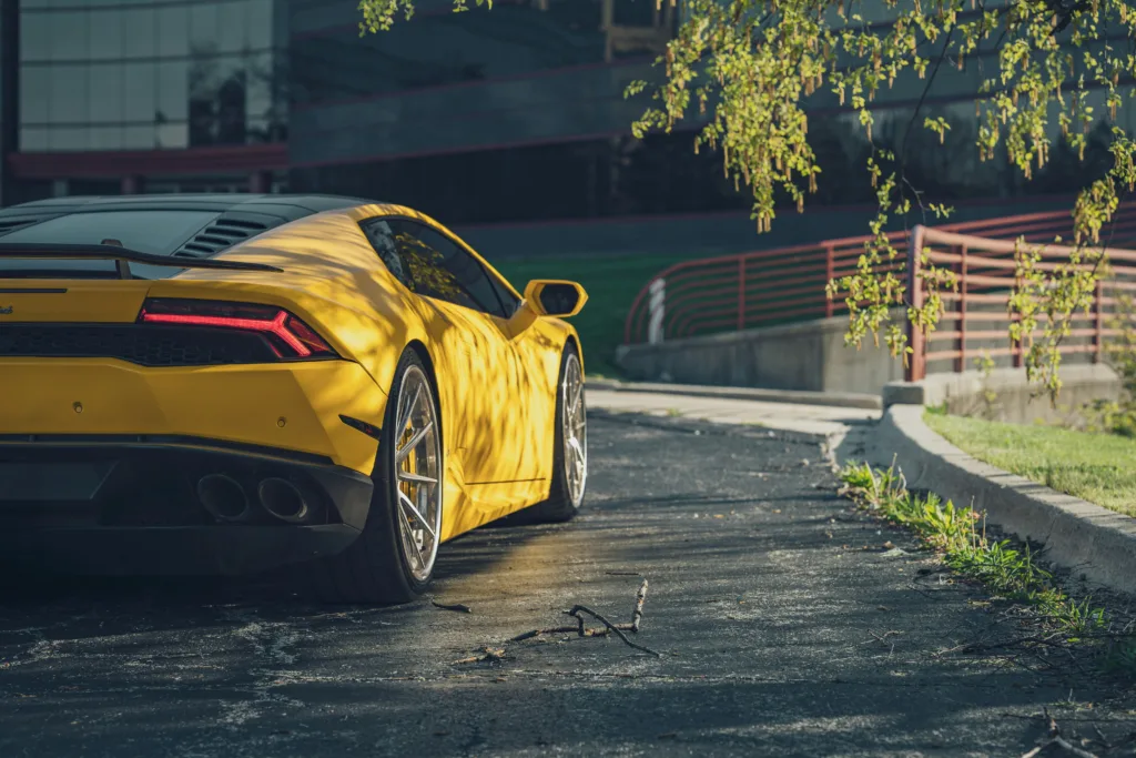 a yellow sports car parked on the side of the road