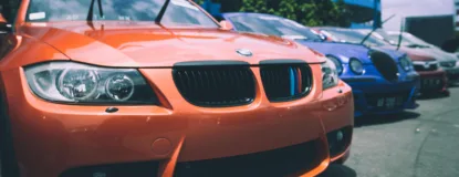 Orange Bmw Car Beside Blue Bugatti Car