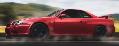 Red Nissan Gt-r R34 Skyline Running on Road