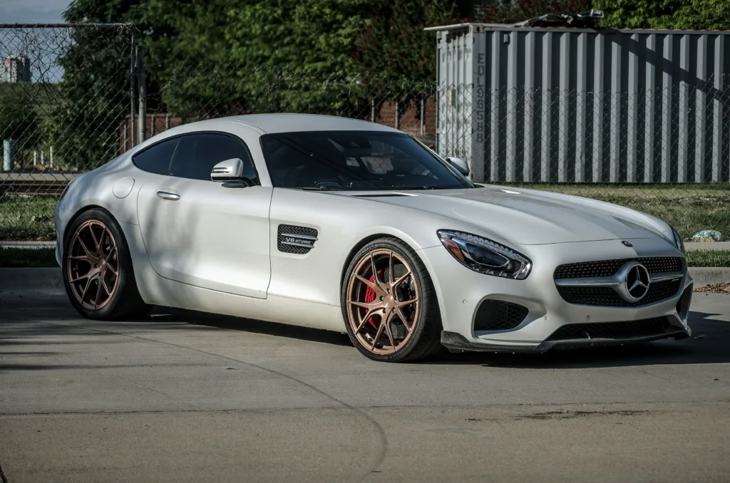 a white mercedes sports car parked in a parking lot