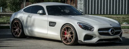 a white mercedes sports car parked in a parking lot