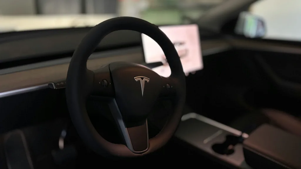 A tesla's steering wheel and interior.