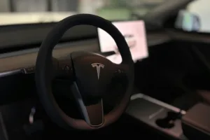 A tesla's steering wheel and interior.