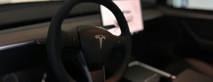 A tesla's steering wheel and interior.