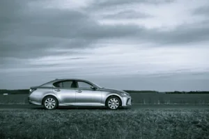Silver mercedes benz coupe on road under cloudy sky