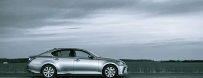 Silver mercedes benz coupe on road under cloudy sky