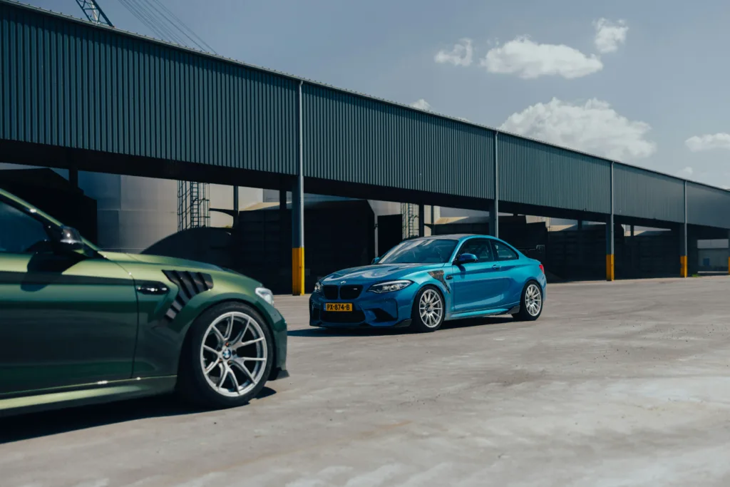 two cars parked next to each other in front of a building
