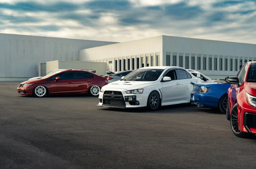 Several sports cars parked outside a building