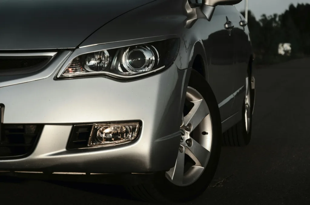 a silver car's headlight is in focus.