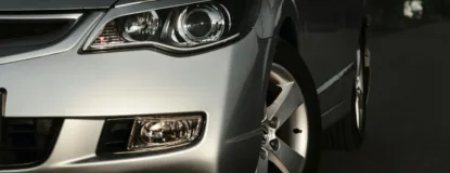 a silver car's headlight is in focus.