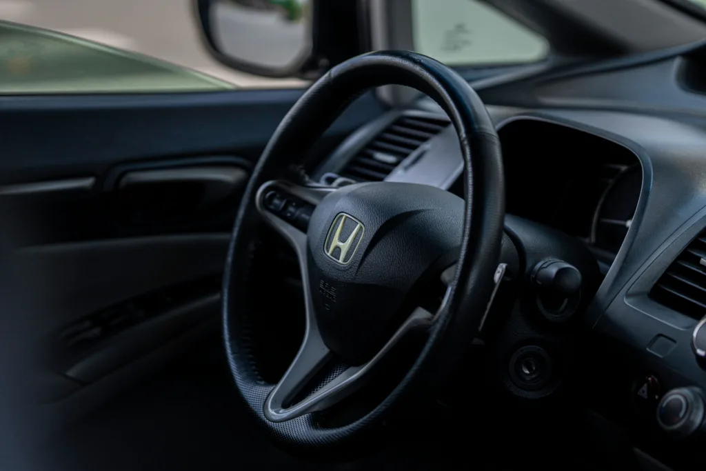 the interior of a car with a steering wheel