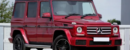 Red Mercedes-Benz G-Class SUV parked in an outdoor lot
