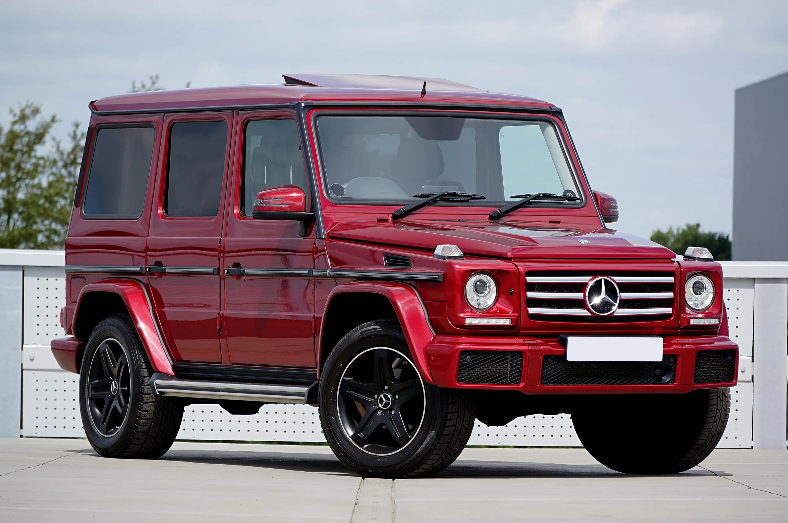 Red Mercedes-Benz G-Class SUV parked in an outdoor lot