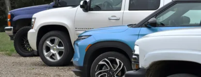 Three suvs parked in a row outdoors