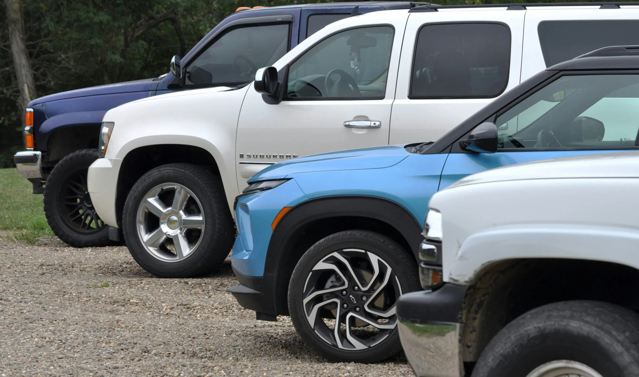 Three suvs parked in a row outdoors