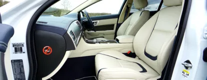 Elegant Jaguar XF car interior featuring premium leather seats and modern design elements.