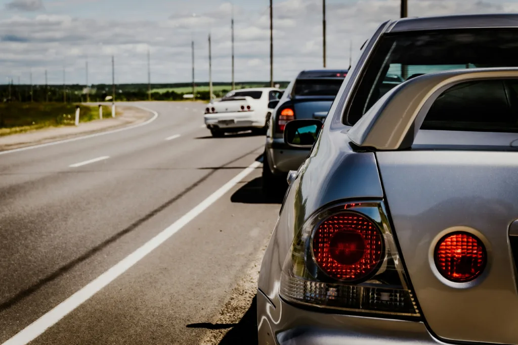 Cars stopped on the side of a highway