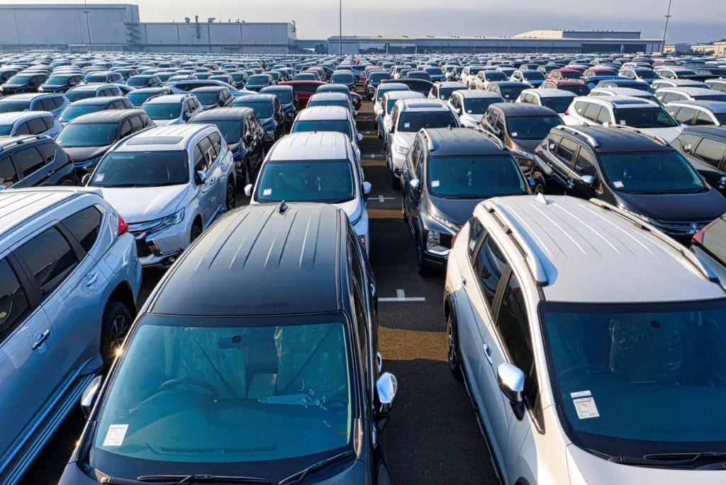 Aerial view showing a vast parking lot filled with parked cars under daylight in West Java
