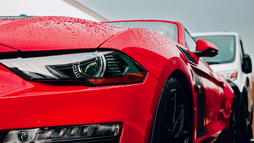 a close up of the front of a red sports car